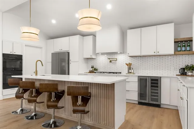 a kitchen with cabinets a sink stainless steel appliances and cabinets