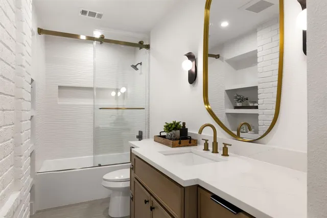 a bedroom with a bed and a dresser next to a window