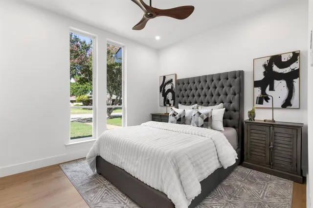 a bedroom with a bed and a painting on the wall