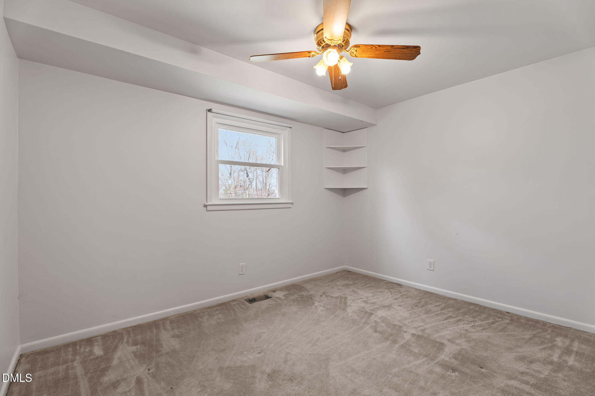 6409 Arrington Road Raleigh, NC 27607 - Photo 16 of 39 an empty room with windows and chandelier fan