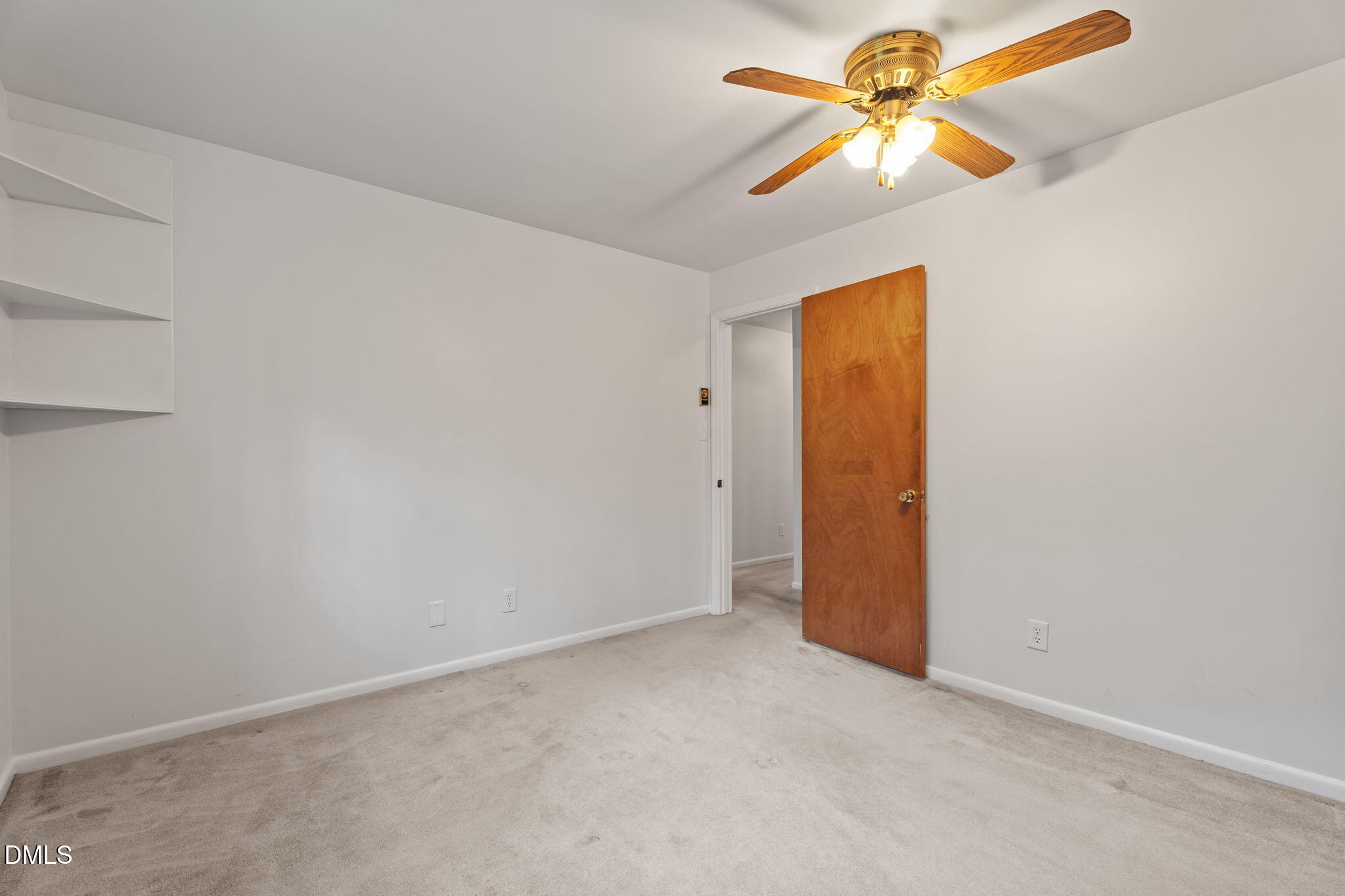 6409 Arrington Road Raleigh, NC 27607 - Photo 20 of 39 an empty room with closet and a chandelier fan