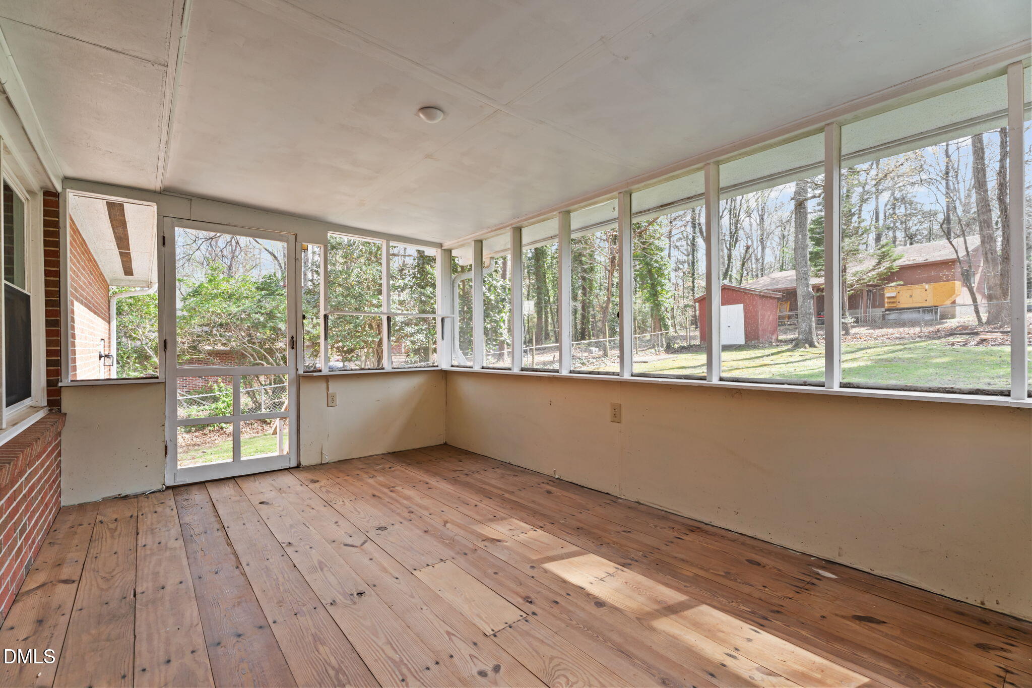 6409 Arrington Road Raleigh, NC 27607 - Photo 28 of 39 a view of an empty room with a window and wooden floor
