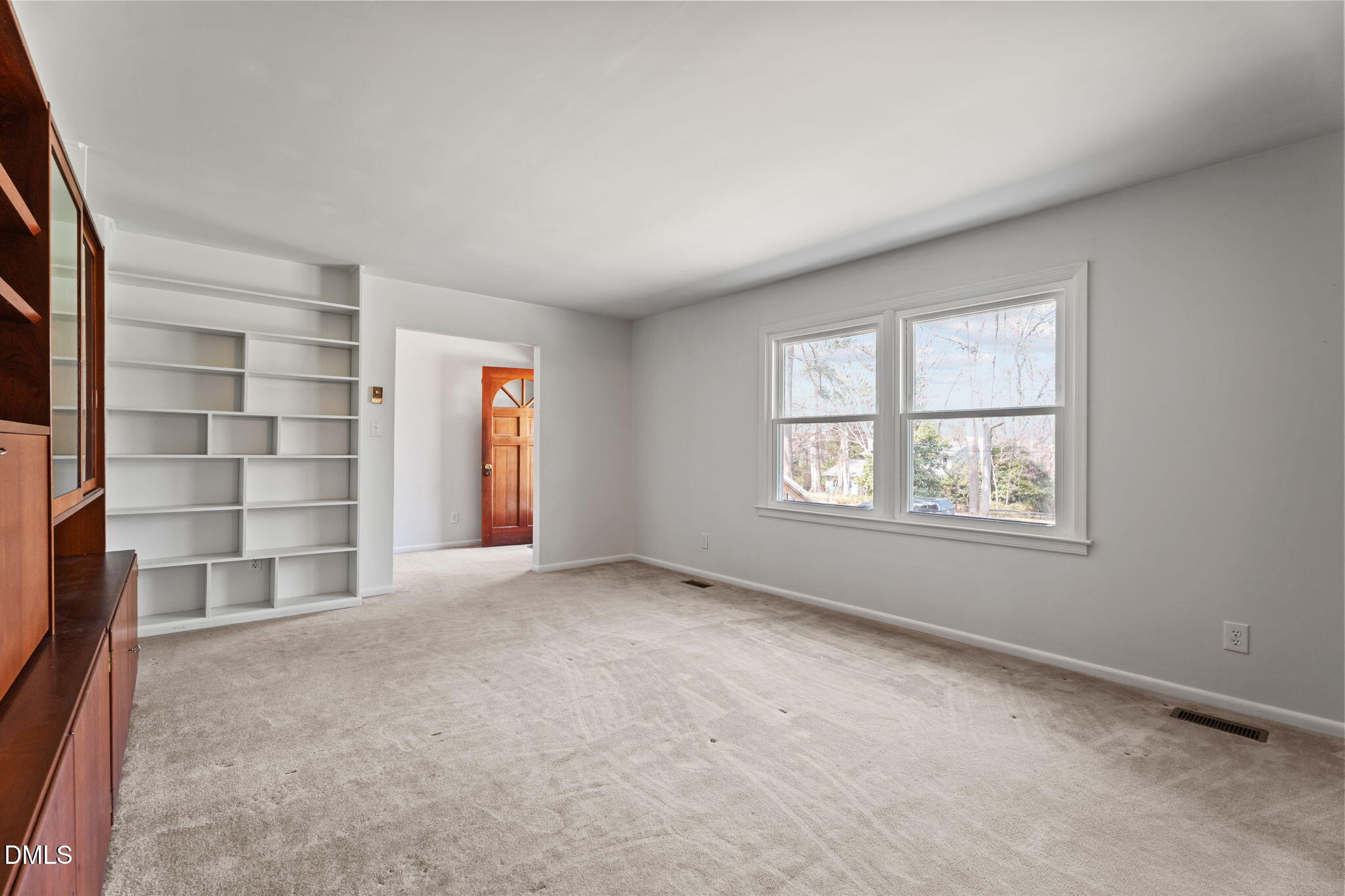 6409 Arrington Road Raleigh, NC 27607 - Photo 5 of 39 an empty room with windows closet and natural light