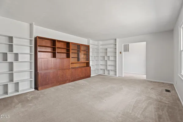 a view of an empty room with a fireplace