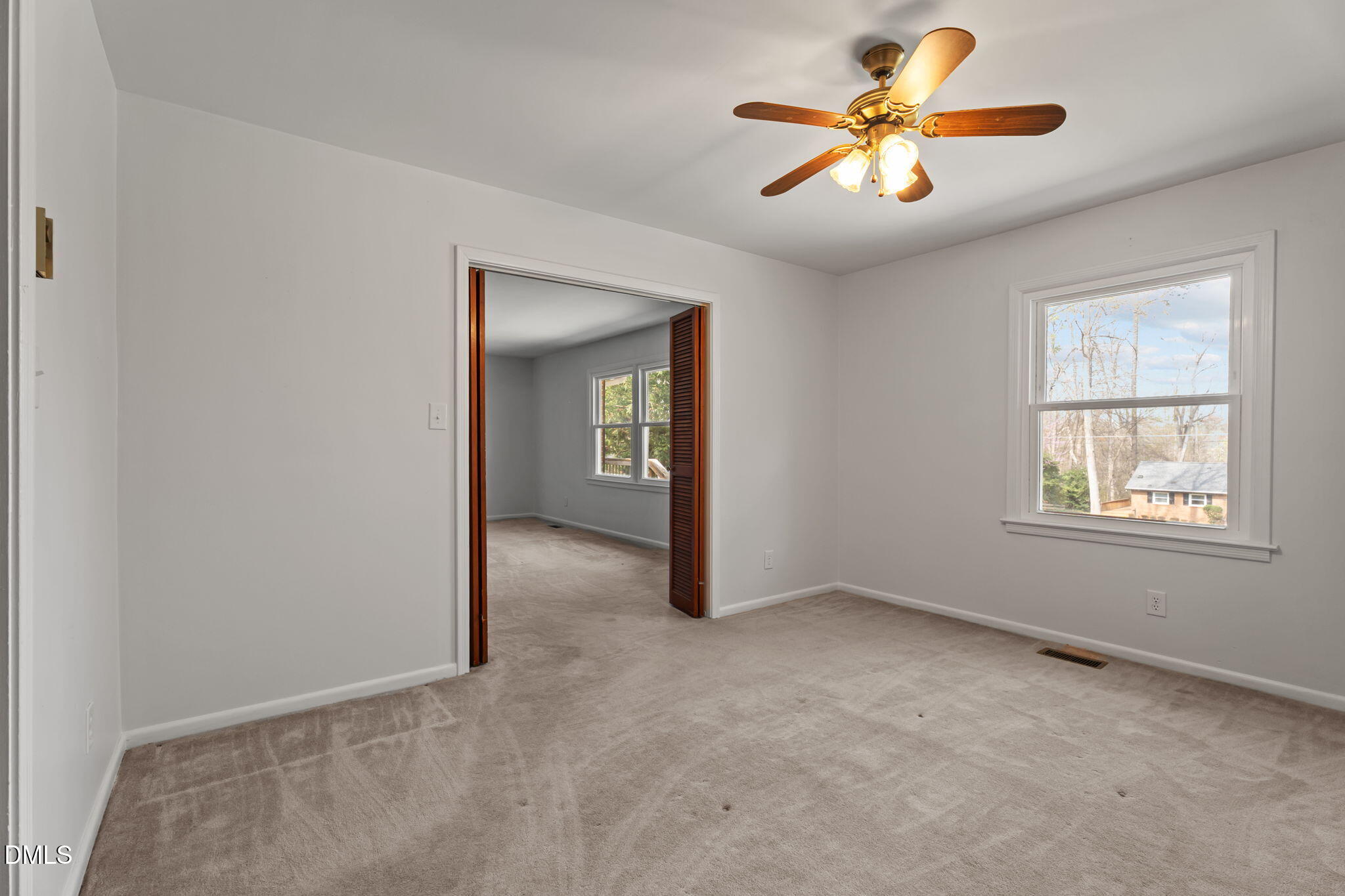 6409 Arrington Road Raleigh, NC 27607 - Photo 8 of 39 an empty room with chandelier fan and windows