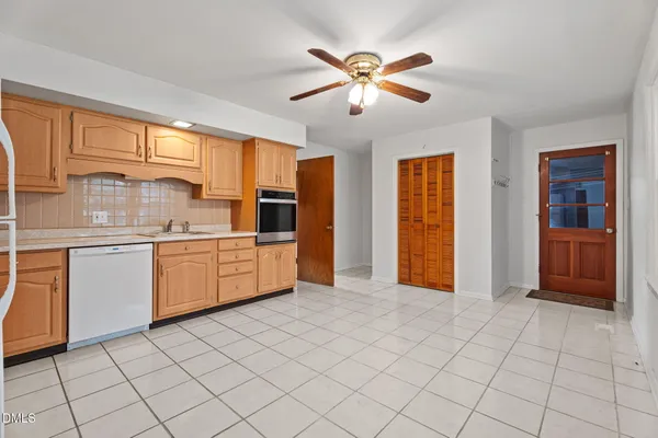 a kitchen with stainless steel appliances a sink and cabinets