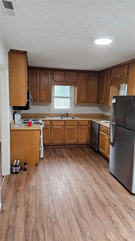 471 Perkins Circle Canton, GA 30115 - Photo 11 of 20 a kitchen with wooden floors and refrigerator