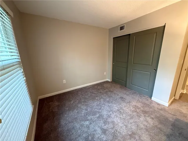 a view of an empty room with closet
