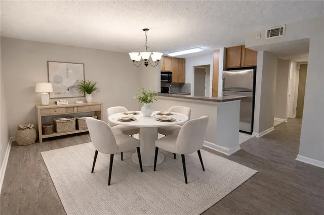 a view of a dining room with furniture wooden floor and a chandelier