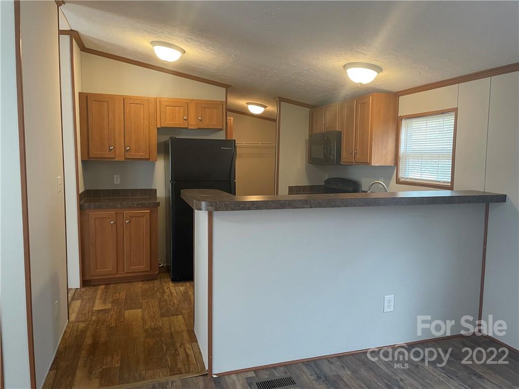 2542 Center Road Chester, SC 29706 - Photo 3 of 17 a kitchen with stainless steel appliances granite countertop a refrigerator and a sink