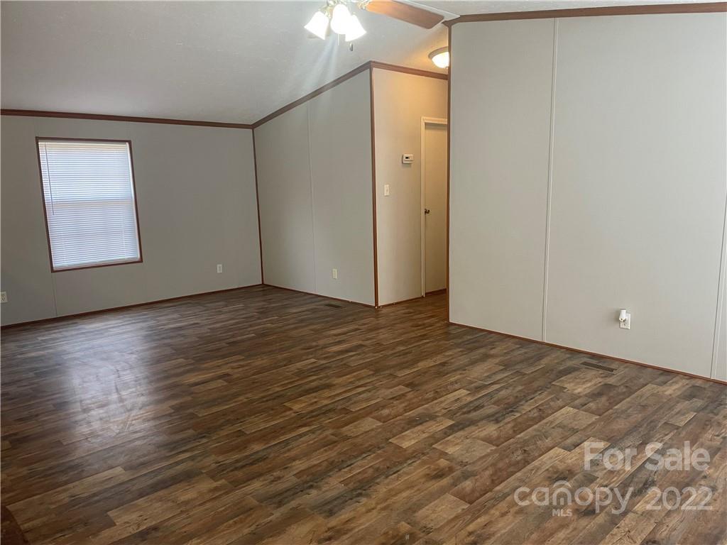 2542 Center Road Chester, SC 29706 - Photo 6 of 17 a view of an empty room with wooden floor and a window