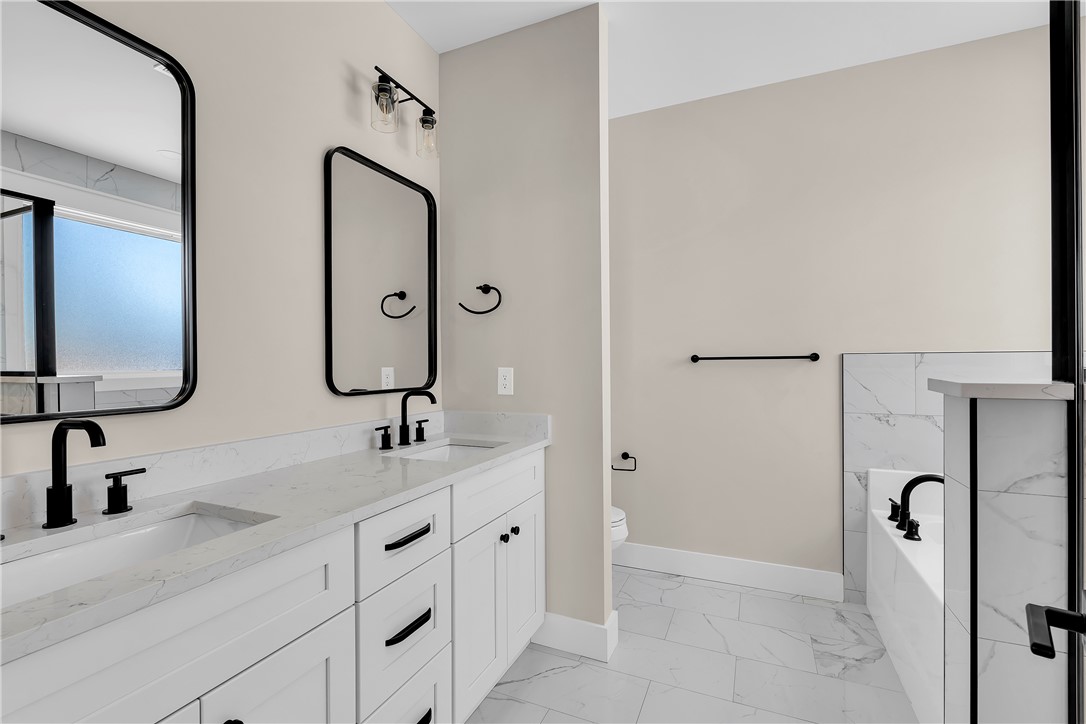 2816 Smith McGee Road Iva, SC 29655 - Photo 16 of 25 Dual vanities and a deep soaking tub create a personal spa retreat.