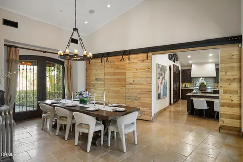a living room with furniture a flat screen tv and a large window