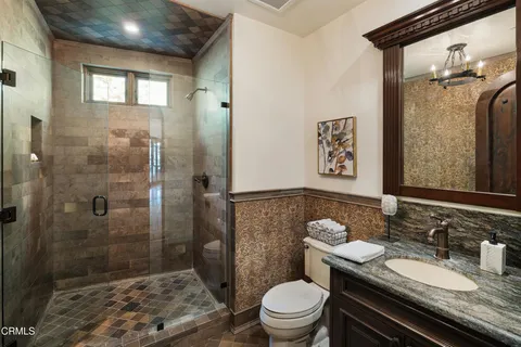 a bedroom with furniture and a chandelier