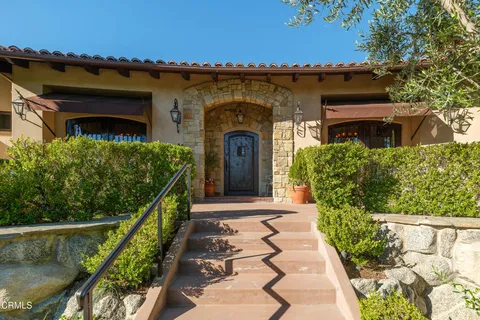 a living room with lots of furniture and a chandelier