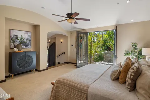 a bathroom with a toilet a sink a mirror and shower