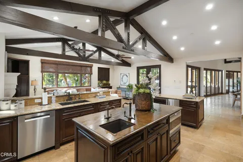 a room with furniture and view of kitchen