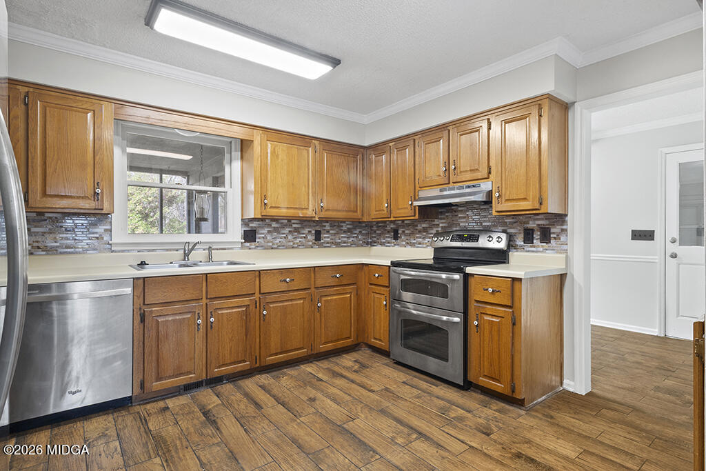 407 Smoke Rise Drive Warner Robins, GA 31088 - Photo 18 of 34 a kitchen with stainless steel appliances granite countertop a stove a sink dishwasher and a refrigerator