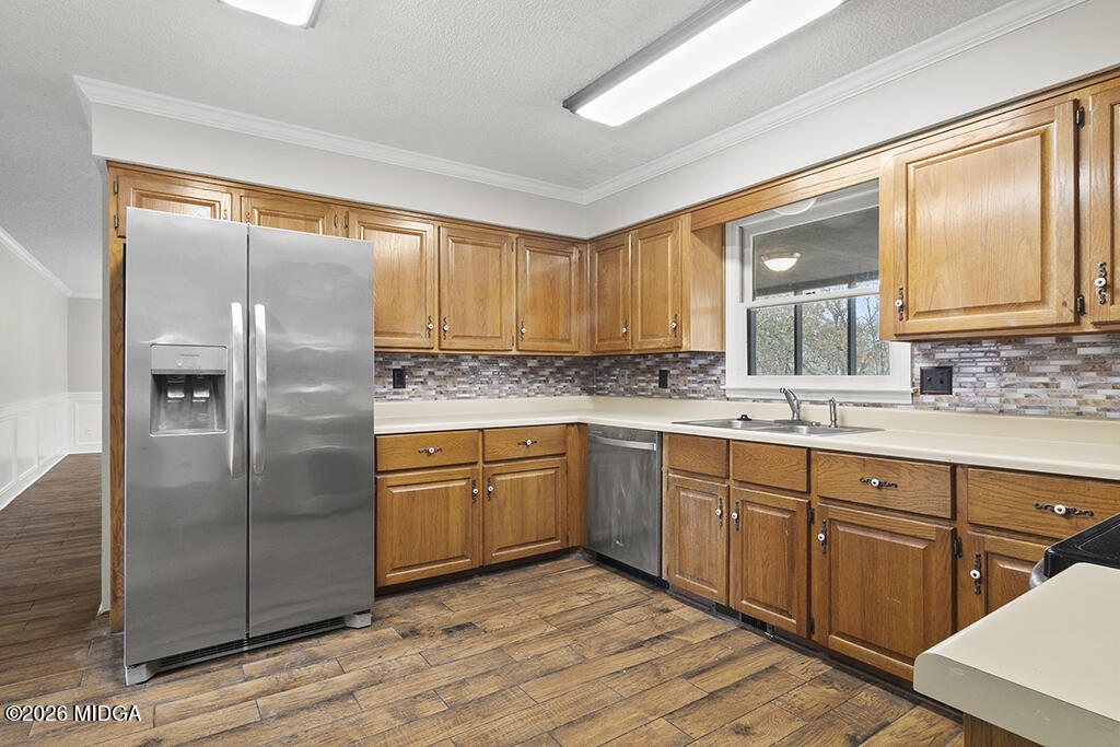 407 Smoke Rise Drive Warner Robins, GA 31088 - Photo 19 of 34 a kitchen with stainless steel appliances granite countertop a refrigerator and wooden cabinets