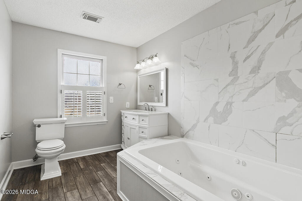 407 Smoke Rise Drive Warner Robins, GA 31088 - Photo 30 of 34 a bathroom with a sink a toilet and bathtub