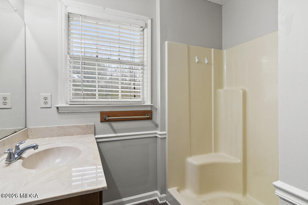 407 Smoke Rise Drive Warner Robins, GA 31088 - Photo 34 of 34 a bathroom with a sink a toilet and shower