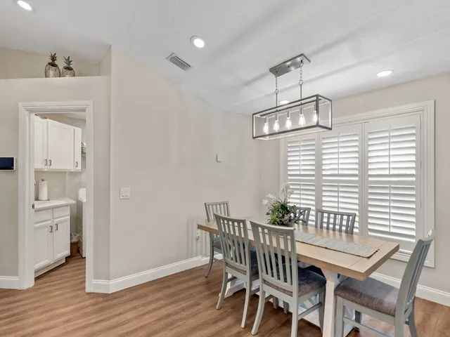 a view of a dining room with furniture wooden floor and chandelier