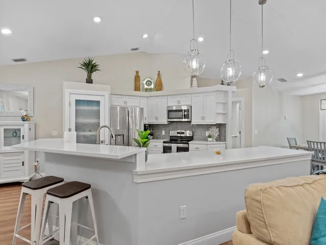 a kitchen with a sink a stove and cabinets