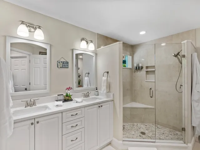 a bathroom with a shower sink and mirror