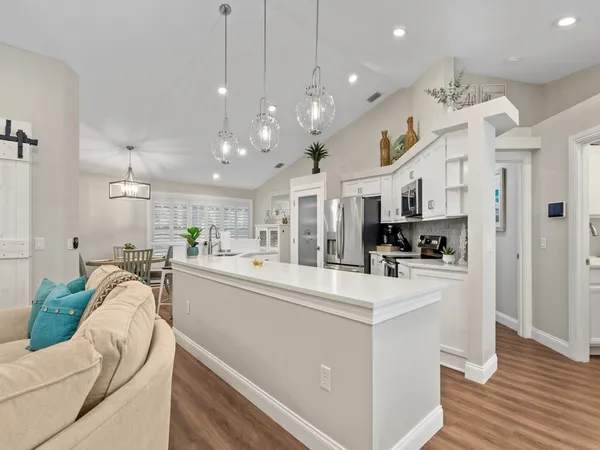 a kitchen with stainless steel appliances kitchen island a refrigerator and a stove