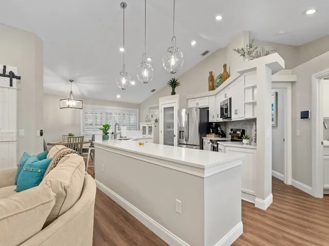 a kitchen with stainless steel appliances kitchen island a refrigerator and a stove