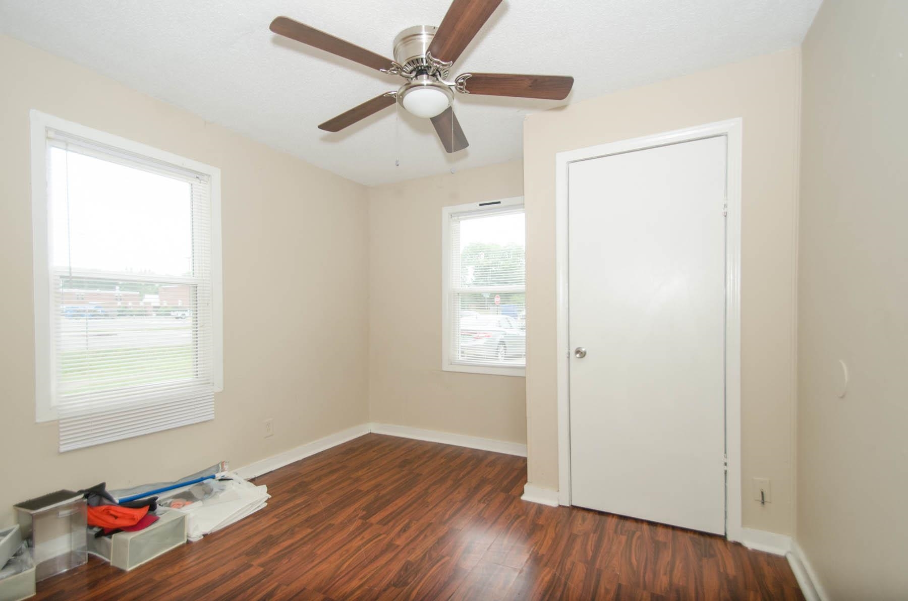 4932 Fairley Road Memphis, TN 38109 - Photo 8 of 10 a view of an empty room with wooden floor and a window