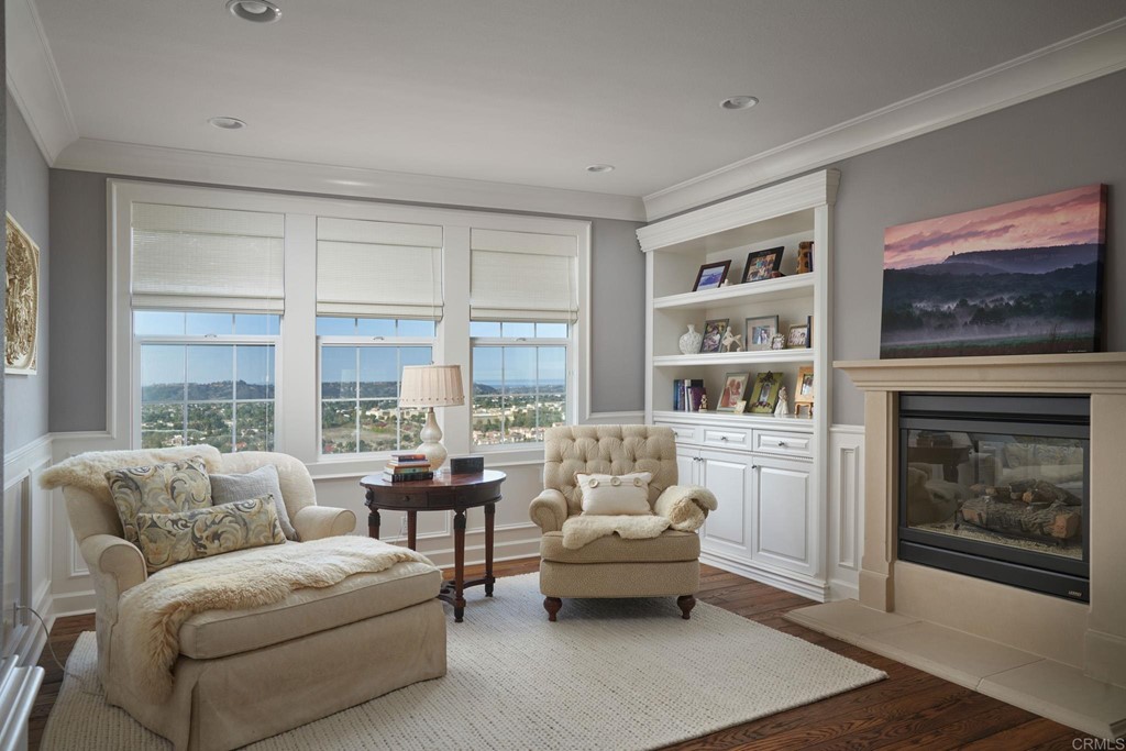 3566 Calle Palmito Carlsbad, CA 92009 - Photo 19 of 40 a living room with furniture a floor to ceiling window and a fireplace