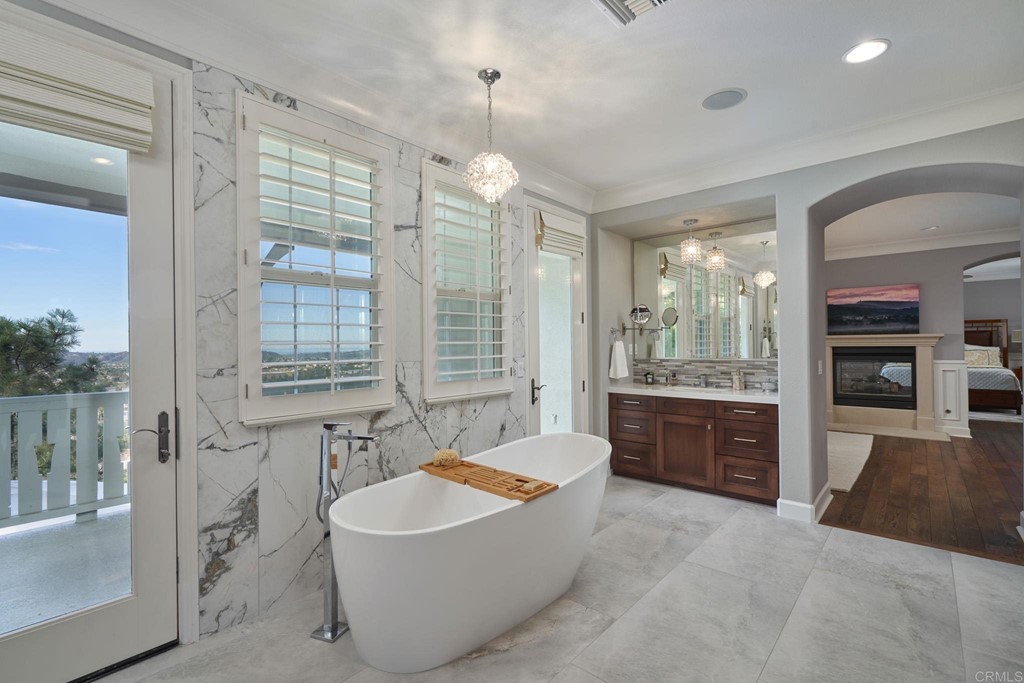 3566 Calle Palmito Carlsbad, CA 92009 - Photo 20 of 40 a spacious bathroom with a granite countertop tub shower and sink