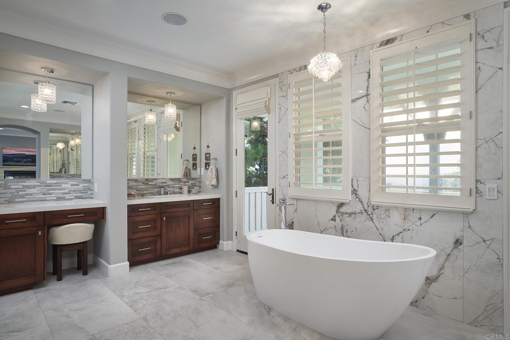 3566 Calle Palmito Carlsbad, CA 92009 - Photo 21 of 40 a spacious bathroom with a tub sink and mirror