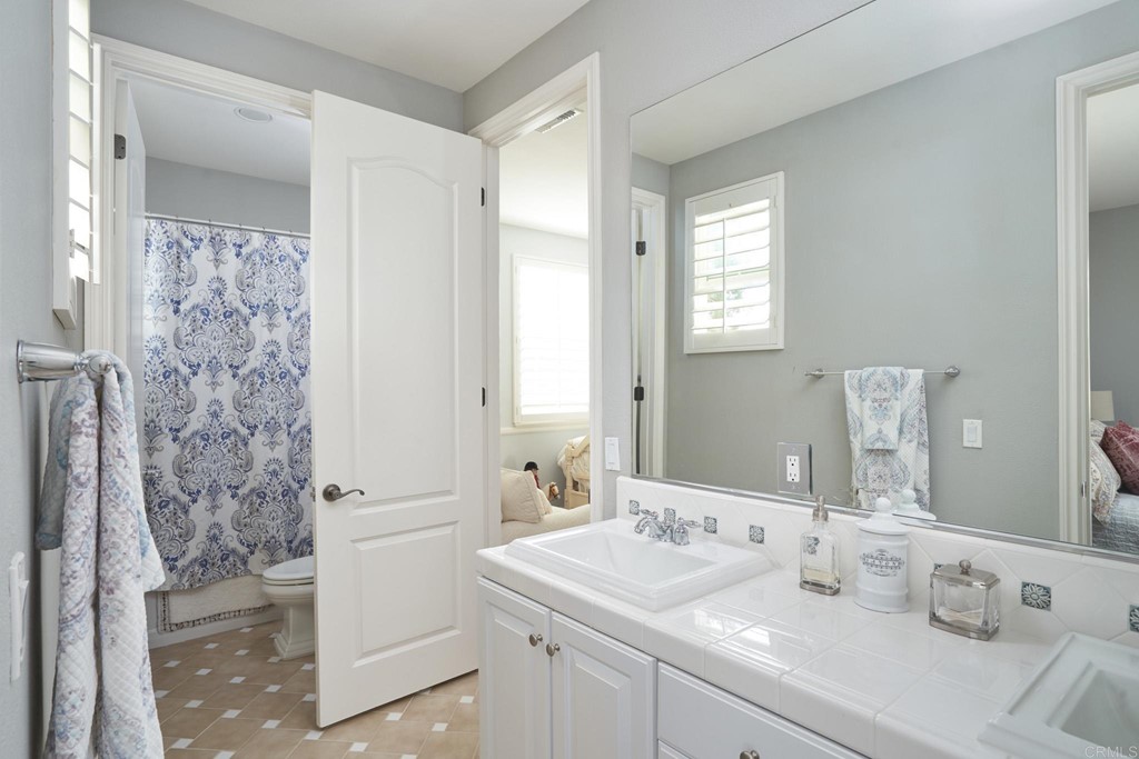 3566 Calle Palmito Carlsbad, CA 92009 - Photo 24 of 40 a bathroom with a sink a toilet and shower