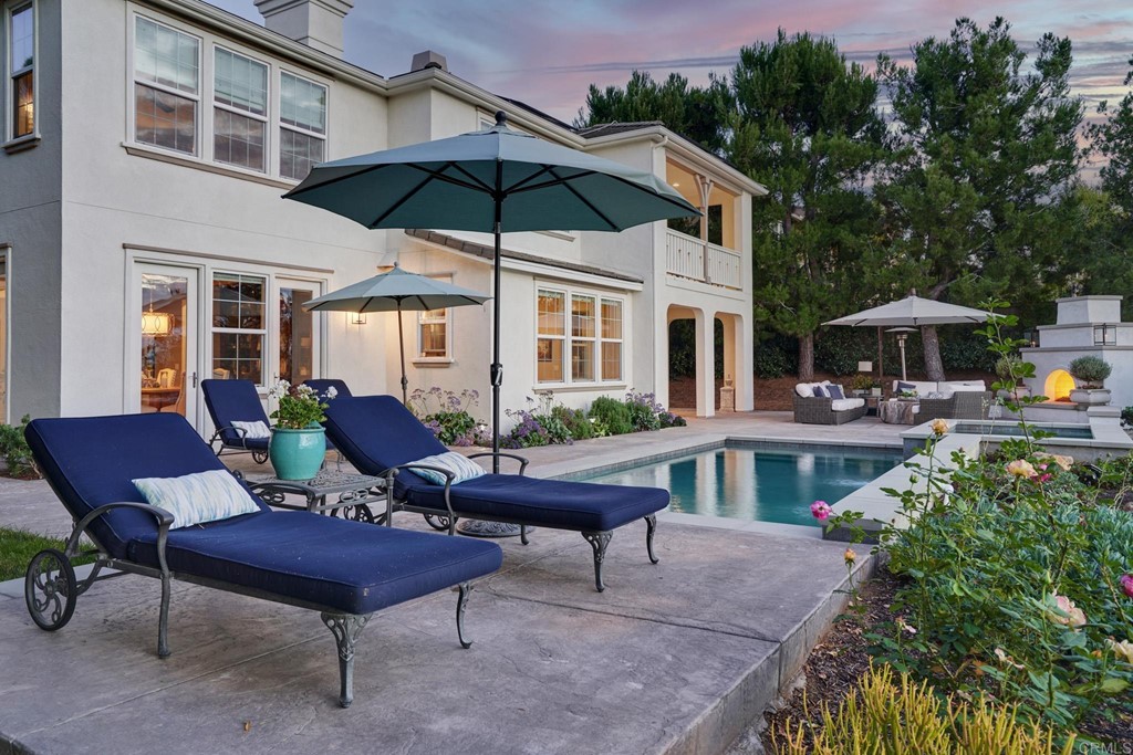 3566 Calle Palmito Carlsbad, CA 92009 - Photo 29 of 40 a view of a patio with a table and chairs under an umbrella
