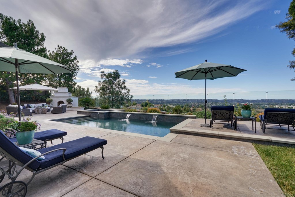 3566 Calle Palmito Carlsbad, CA 92009 - Photo 31 of 40 a view of a patio with a table and chairs under an umbrella