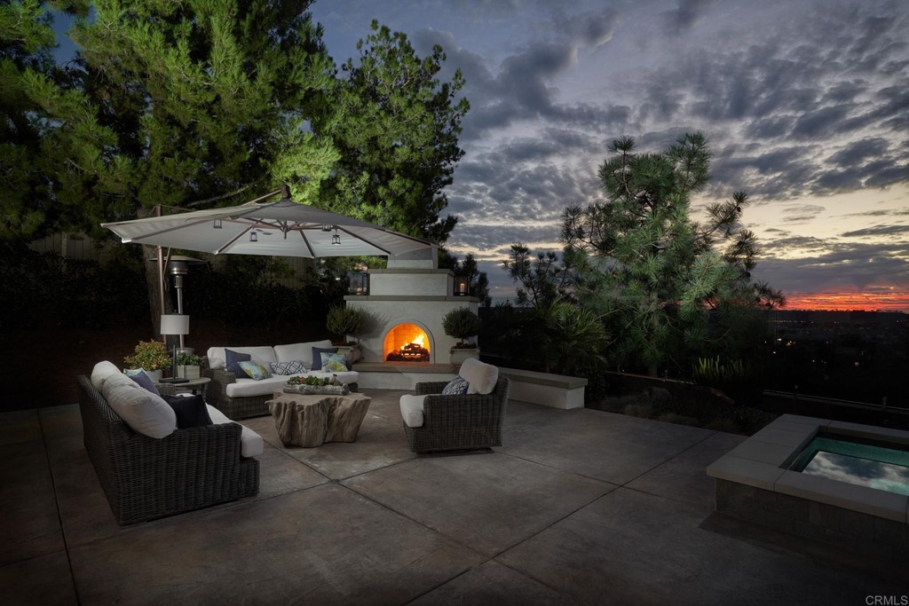 3566 Calle Palmito Carlsbad, CA 92009 - Photo 35 of 40 a view of the patio with couches table and chairs under an umbrella