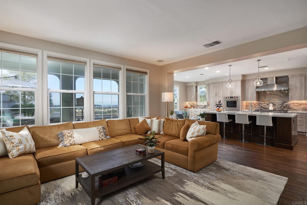 3566 Calle Palmito Carlsbad, CA 92009 - Photo 9 of 40 a living room with furniture wooden floor and a large window