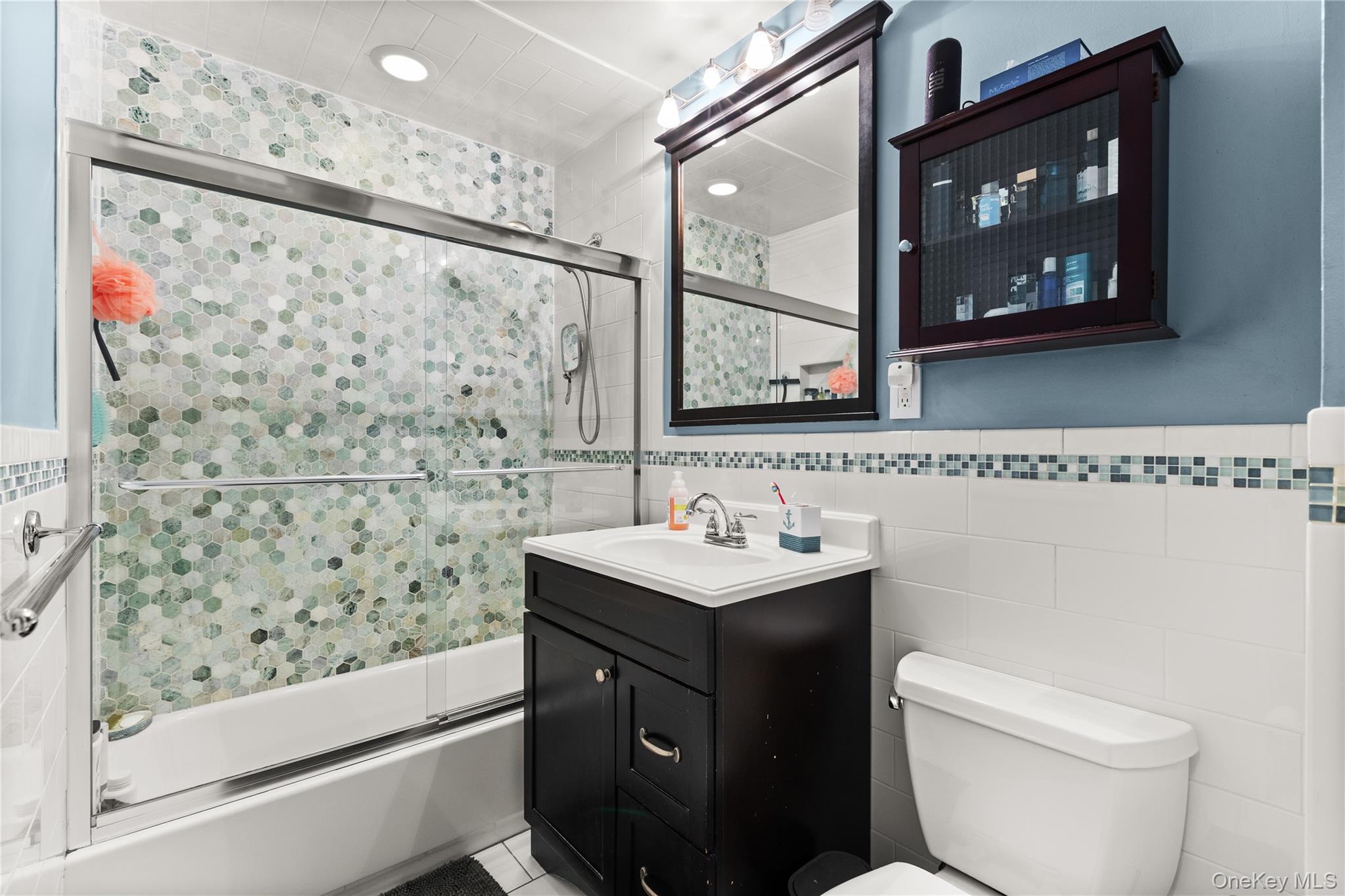 441 Mariners Way Copiague, NY 11726 - Photo 11 of 15 a bathroom with a toilet sink and shower