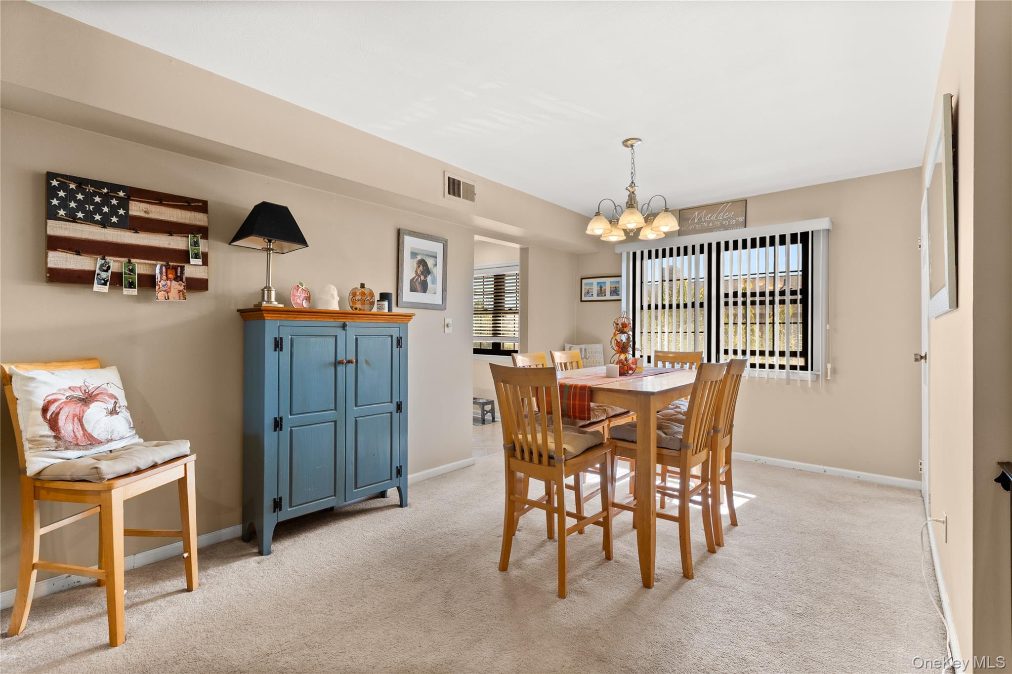 441 Mariners Way Copiague, NY 11726 - Photo 3 of 15 a view of a dining room with furniture and chandelier