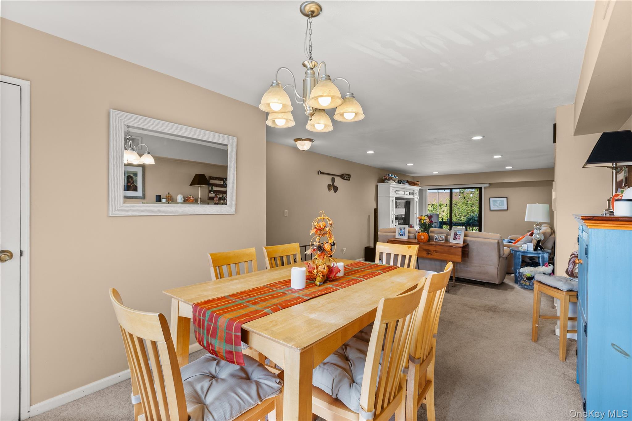 441 Mariners Way Copiague, NY 11726 - Photo 4 of 15 a view of a dining room with furniture and a chandelier