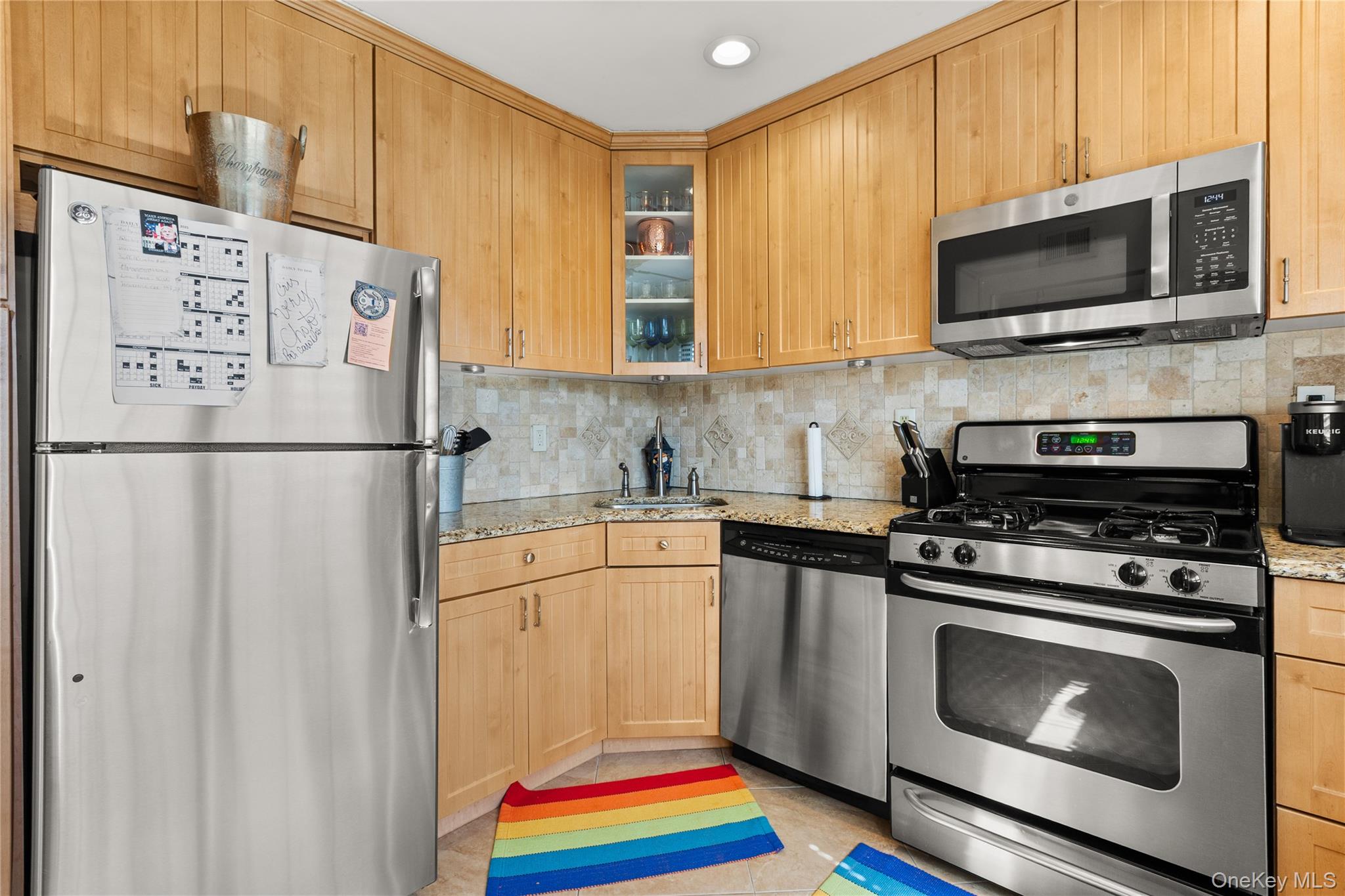 441 Mariners Way Copiague, NY 11726 - Photo 5 of 15 a kitchen with stainless steel appliances granite countertop a refrigerator stove top oven and sink