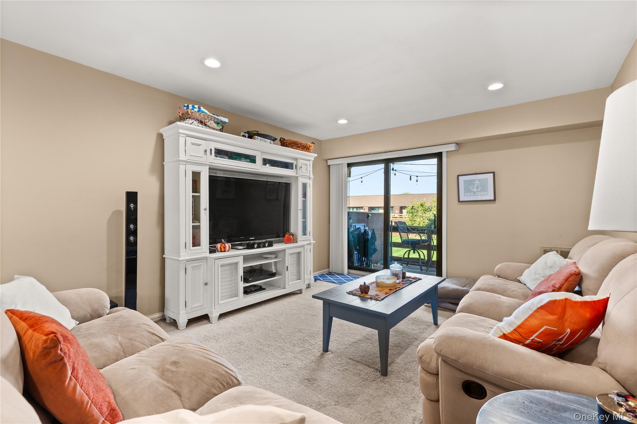 441 Mariners Way Copiague, NY 11726 - Photo 7 of 15 a living room with furniture and a flat screen tv