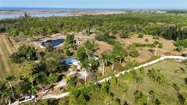 a front view of a house with a garden and tree