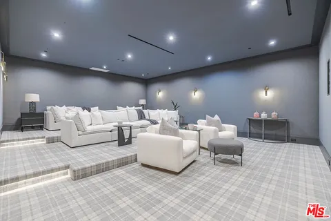 a living room with couches and kitchen view