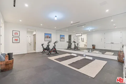 a view of a room with gym equipment and a table