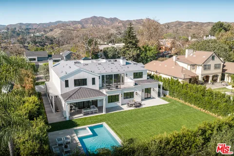an aerial view of a house with a big yard