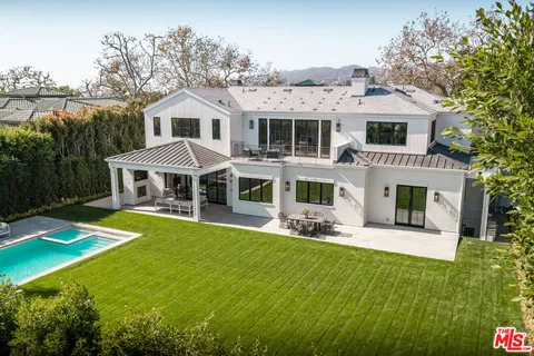 a front view of a house with a yard table and chairs