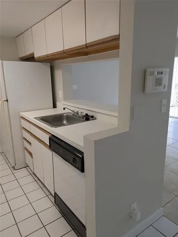 a kitchen with a stove top oven and cabinets